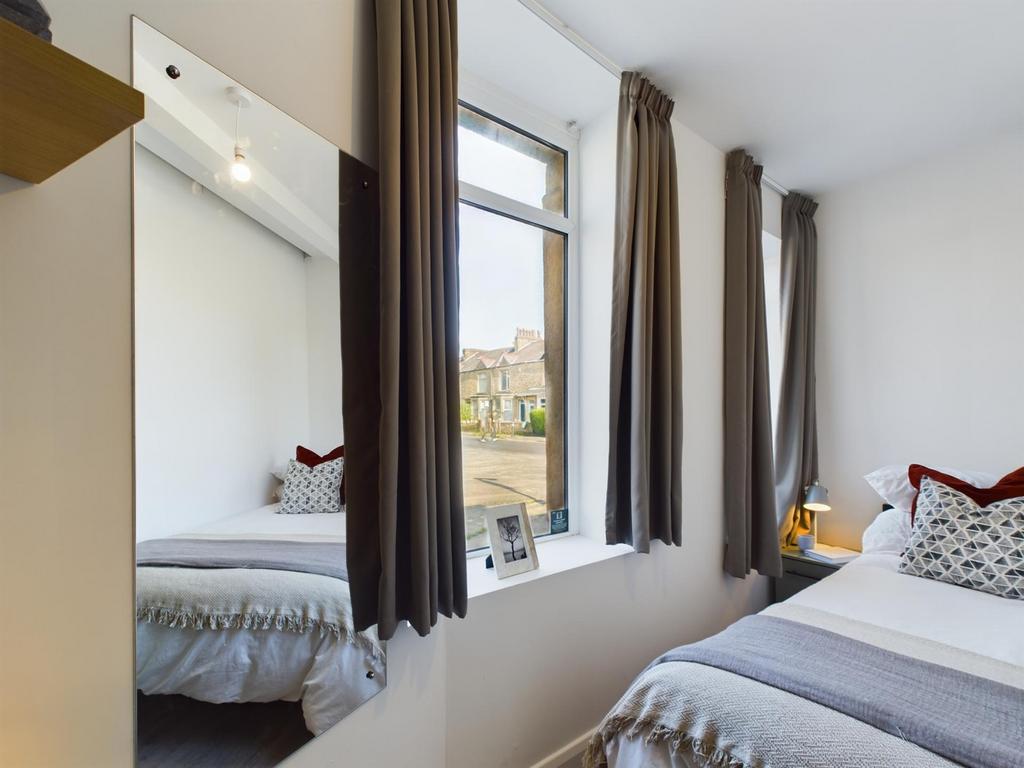 A bright and inviting double bedroom featuring ...