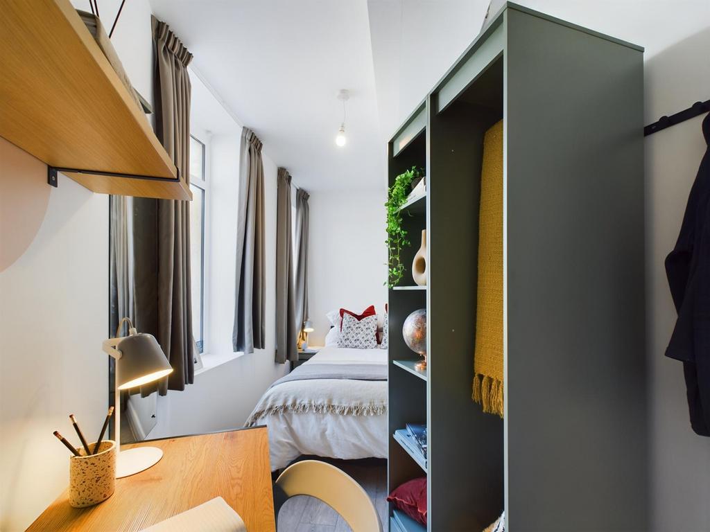 A bright and inviting double bedroom with a stu...