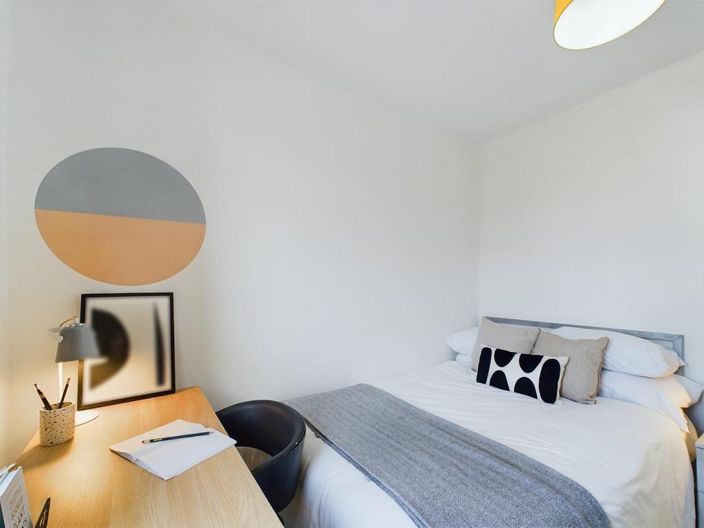 A bright and inviting double bedroom with a sty...