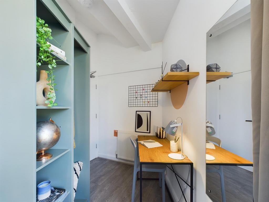 A bright and tidy communal workspace with a sty...