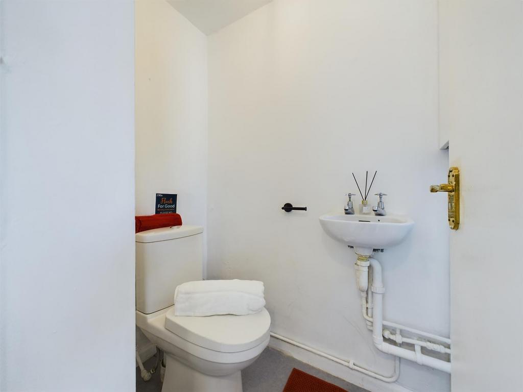A clean and tidy single toilet with modern fixt...