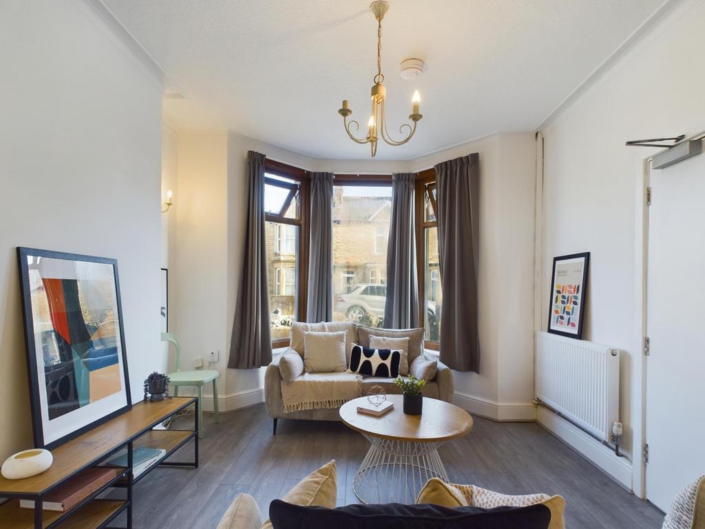 A stylish and spacious living room filled with ...