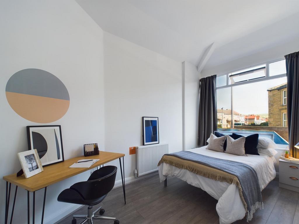 A bright and stylish double bedroom featuring a...