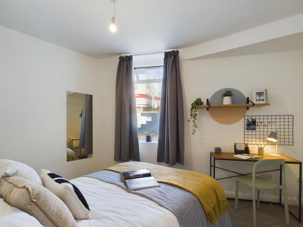 A bright and inviting double bedroom featuring ...