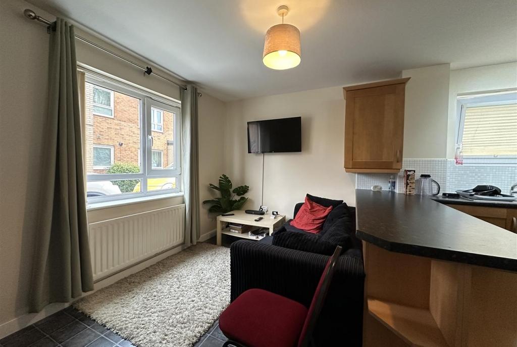 Bright, tidy open-plan living area with large f...