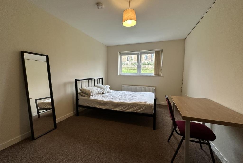 Bright, simply furnished double bedroom with a ...