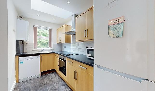 Bright modern galley kitchen with wooden cabine...