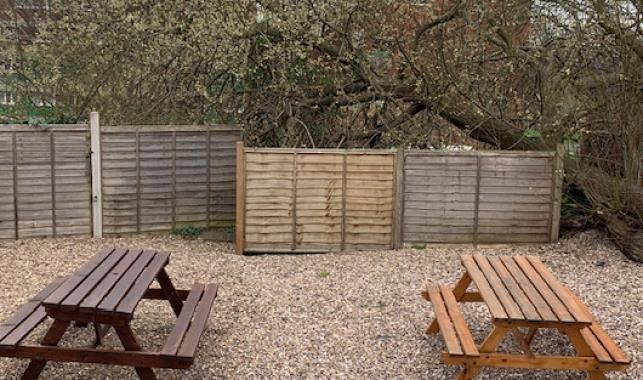 Private gravelled garden with two wooden picnic...