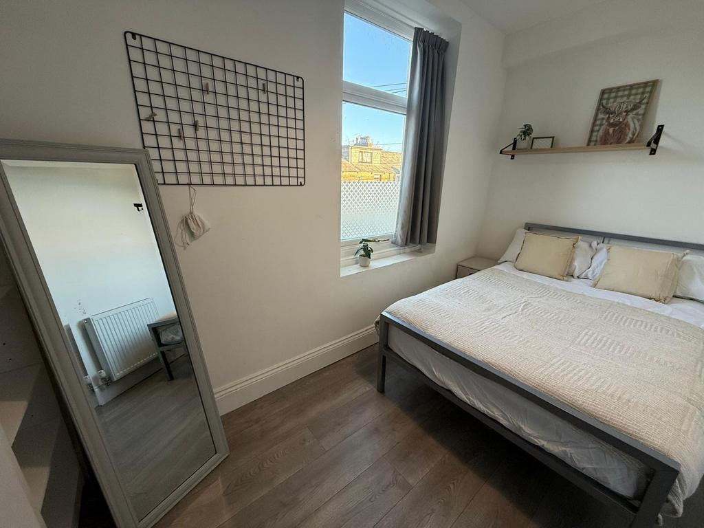Bright, neatly presented bedroom with a double ...