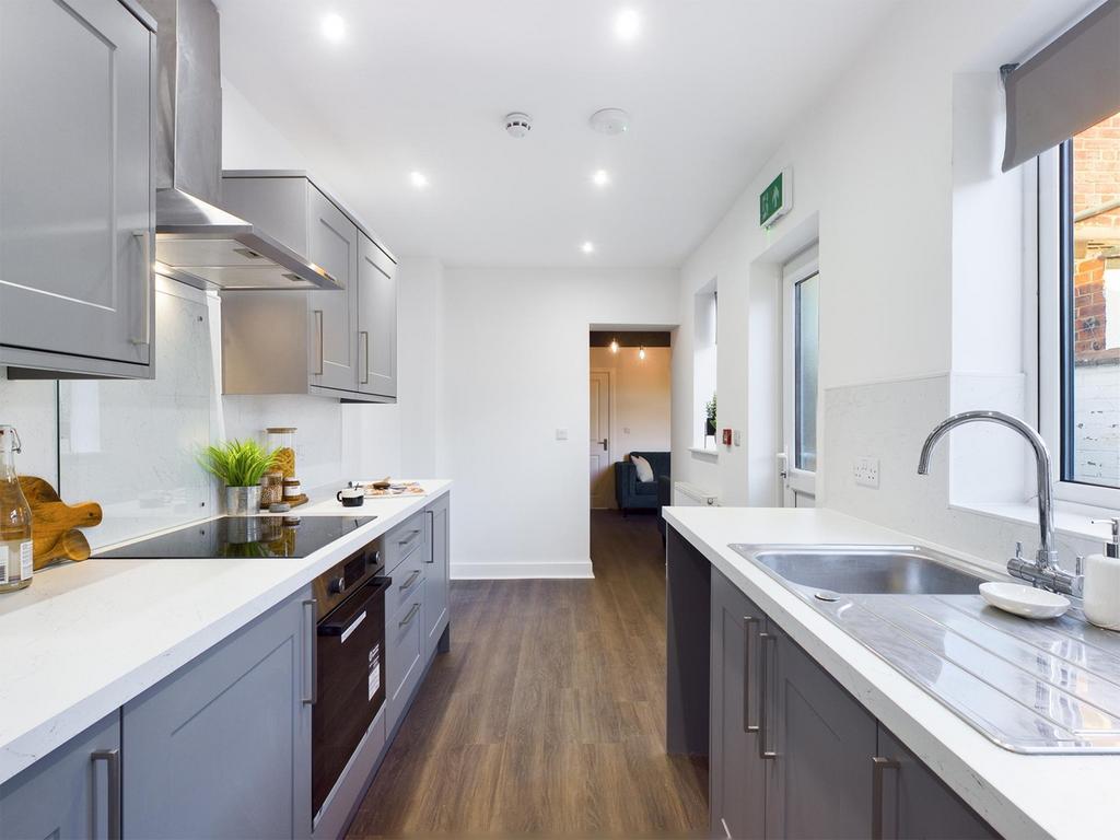 A modern and spacious kitchenette with ample na...