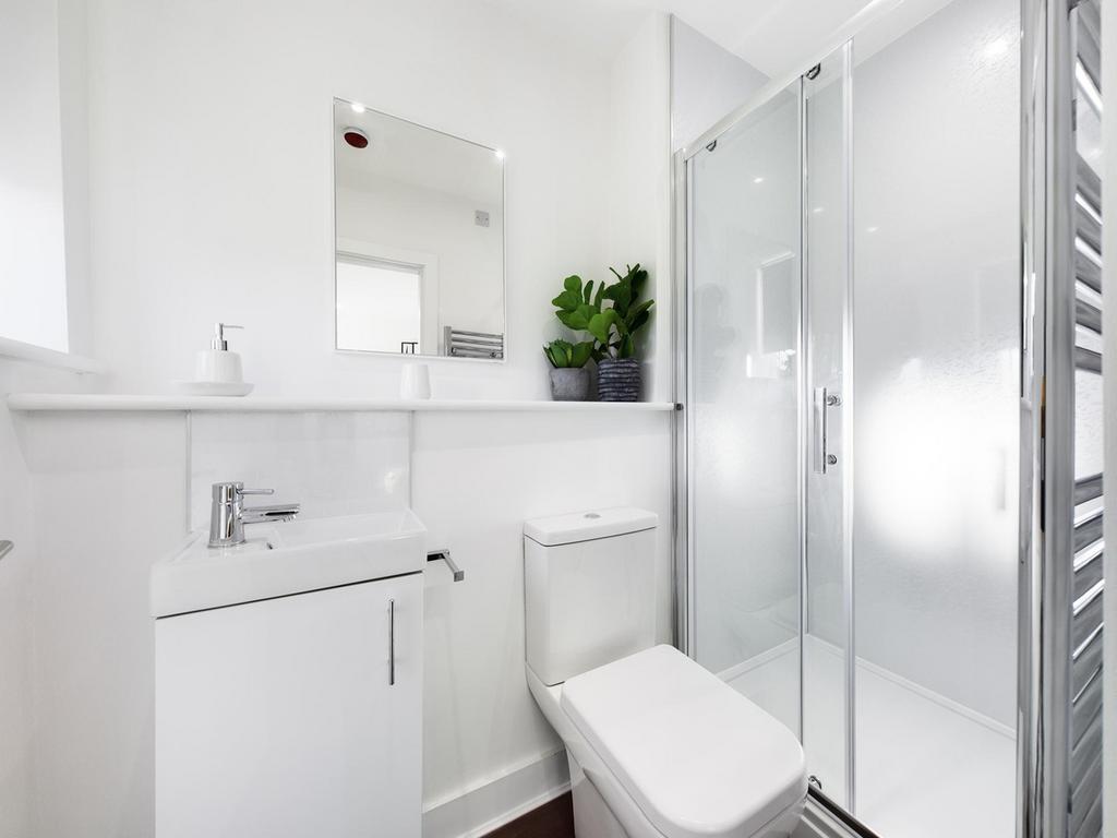 A bright and modern bathroom featuring a sleek ...