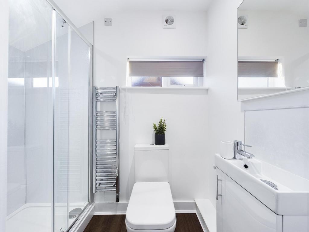 A modern and stylish bathroom featuring a sleek...