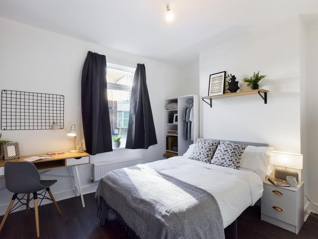 A stylish and inviting double bedroom with ampl...