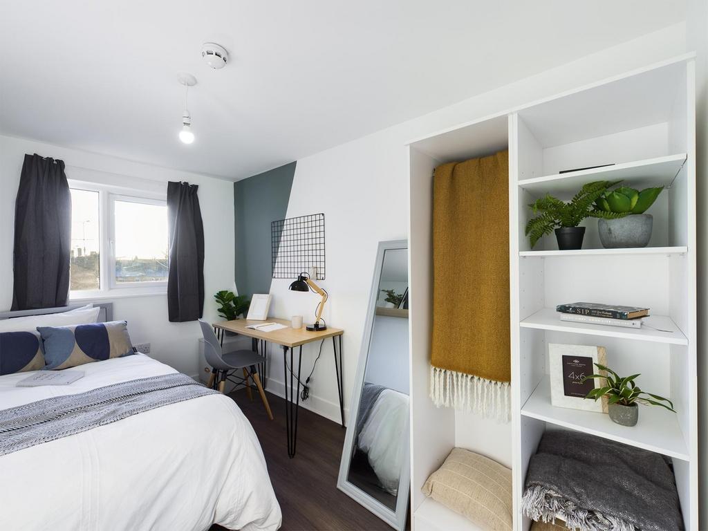 A bright and spacious double bedroom featuring ...