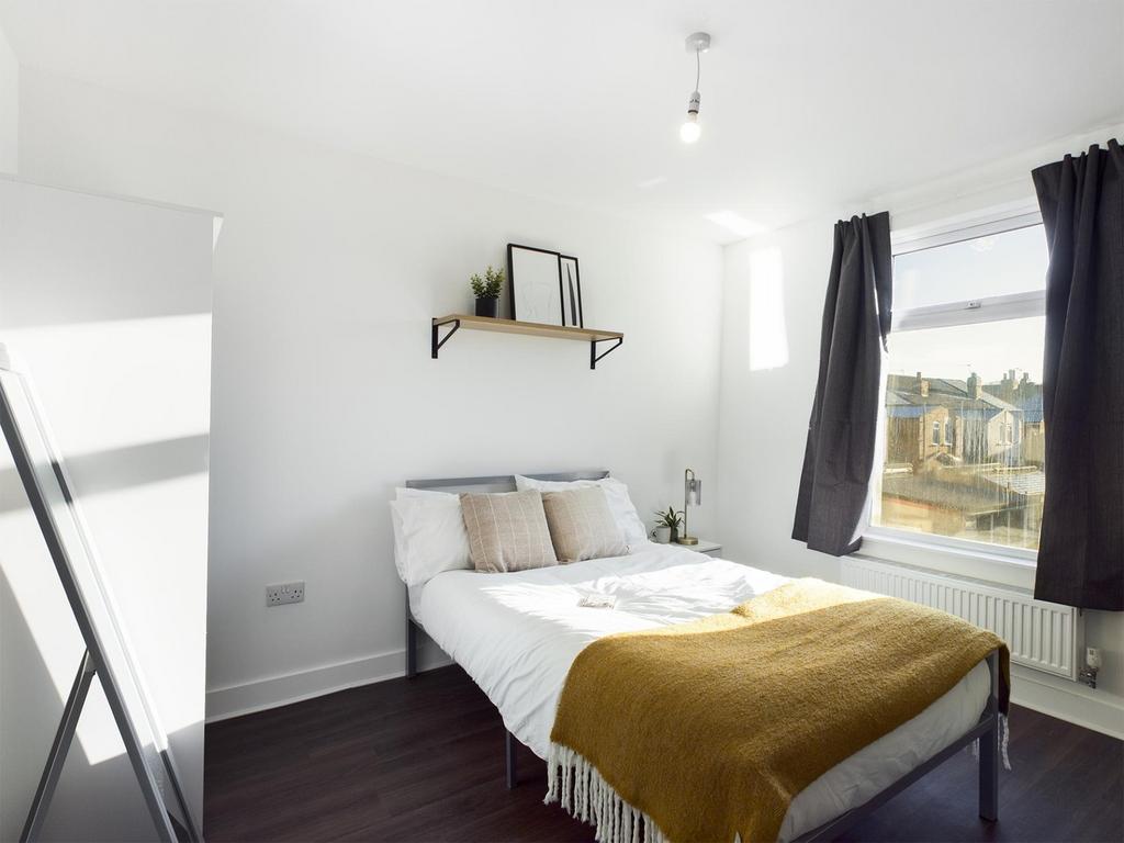 A bright and inviting double bedroom featuring ...