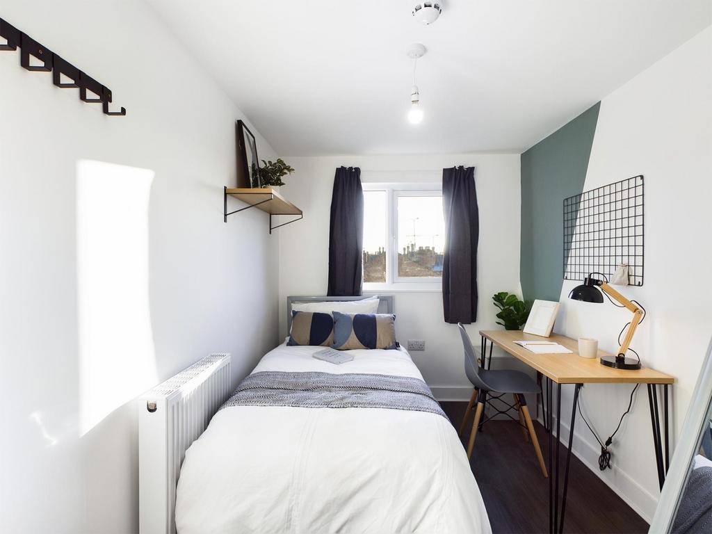 A bright and inviting double bedroom featuring ...