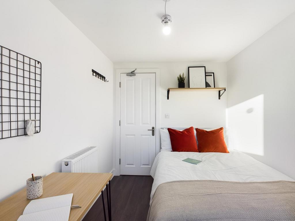 A bright and inviting double bedroom with moder...