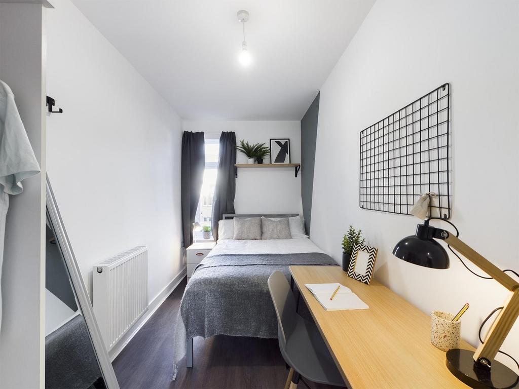 A bright and stylish double bedroom featuring a...