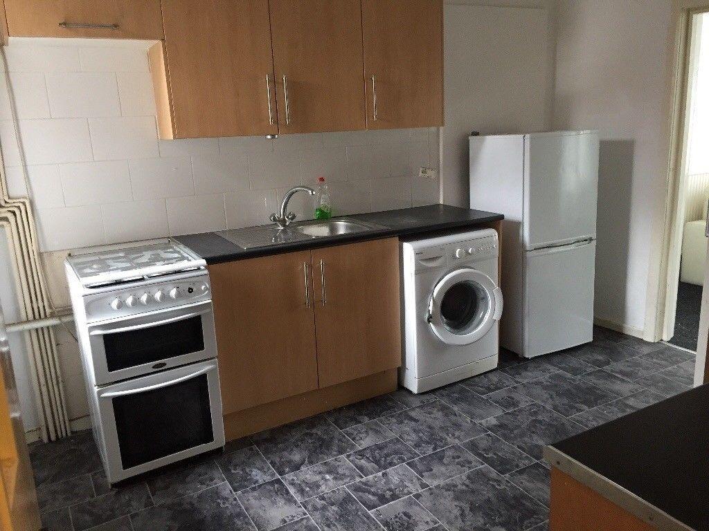 Neat fitted kitchen with matching wood-effect c...