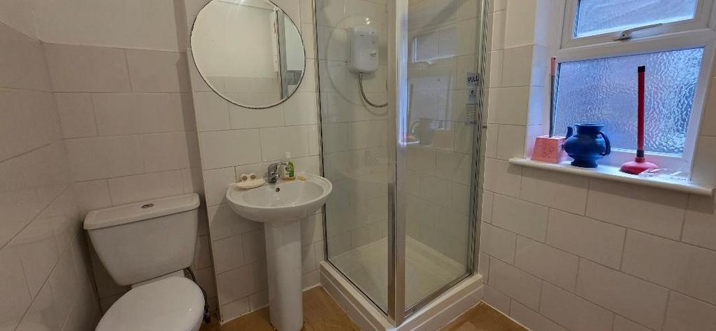Bright bathroom with shower and window...
