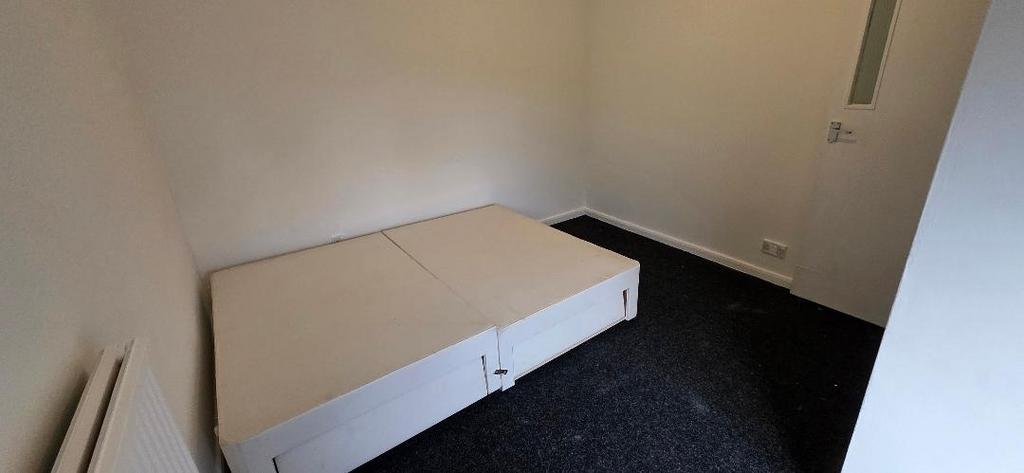Simple bedroom with storage bed and neutral dec...