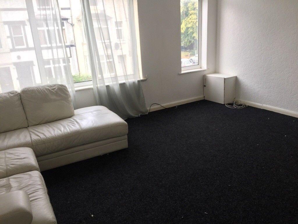 Bright sitting room with large windows, sheer c...