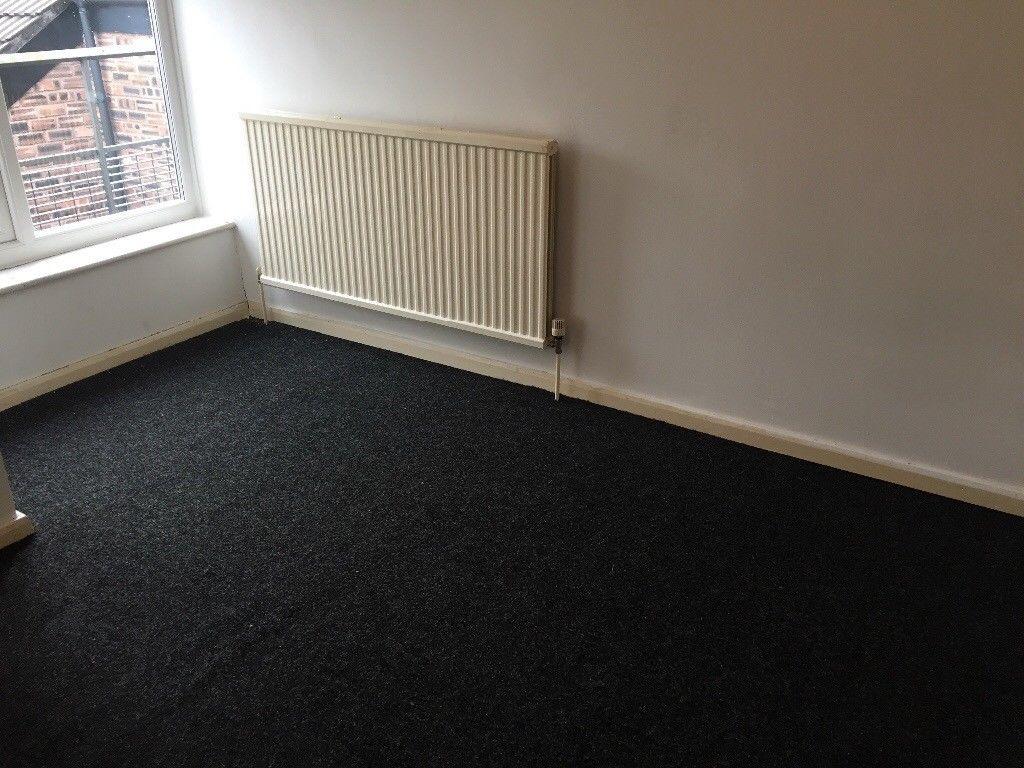 Bright, neutrally painted bedroom with a large ...