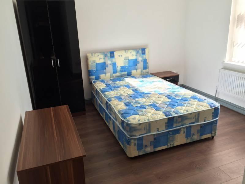 Bright, simply furnished double bedroom with a ...