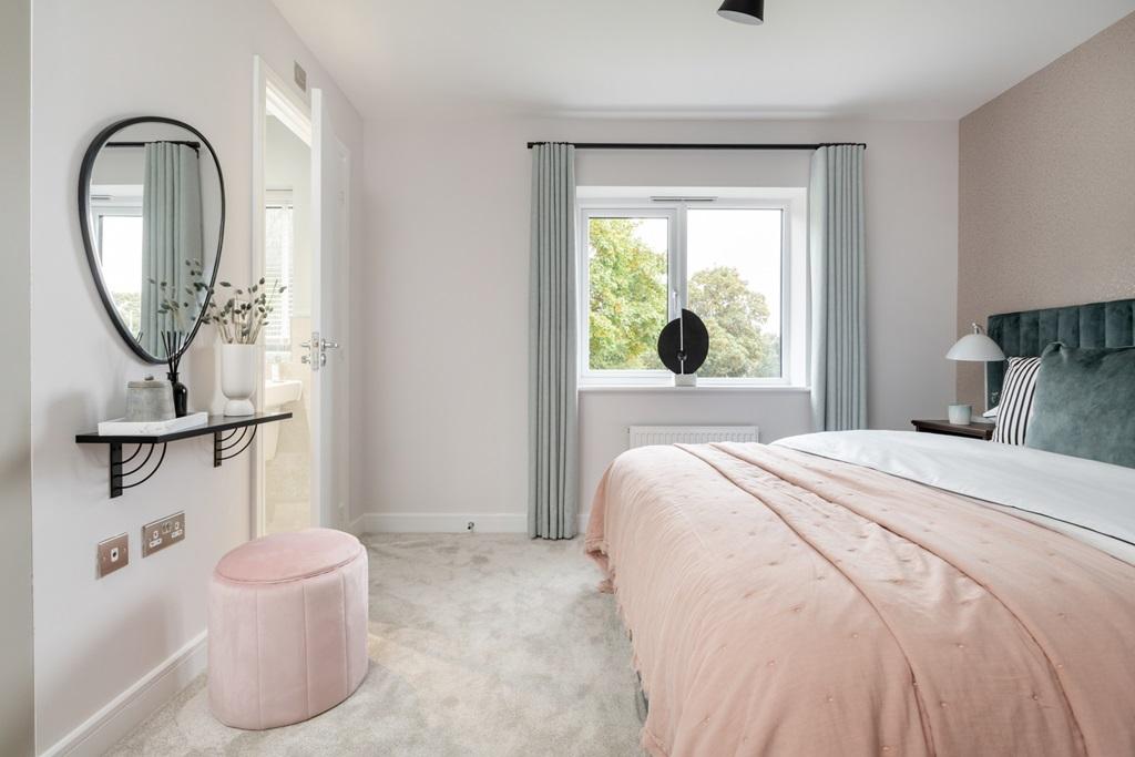 A handy en-suite shower room sits off the main...
