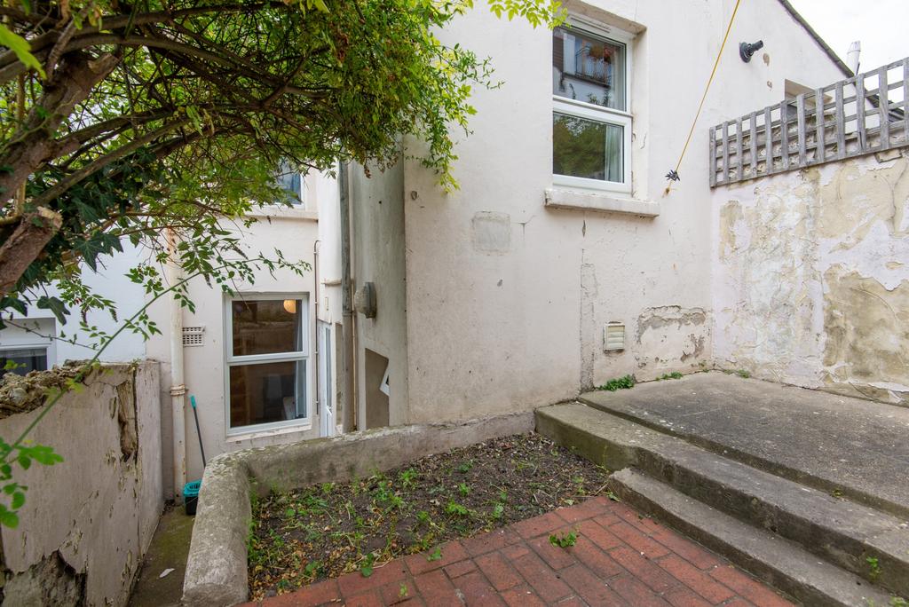 Private paved rear yard with stepped concrete p...