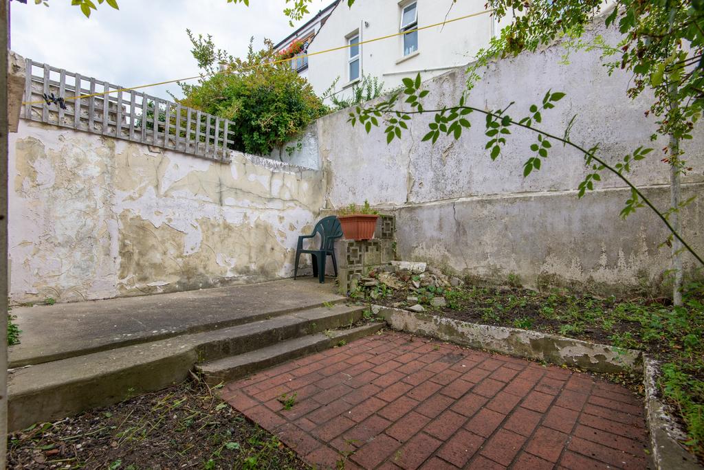 Private rear garden with raised patio steps, pa...