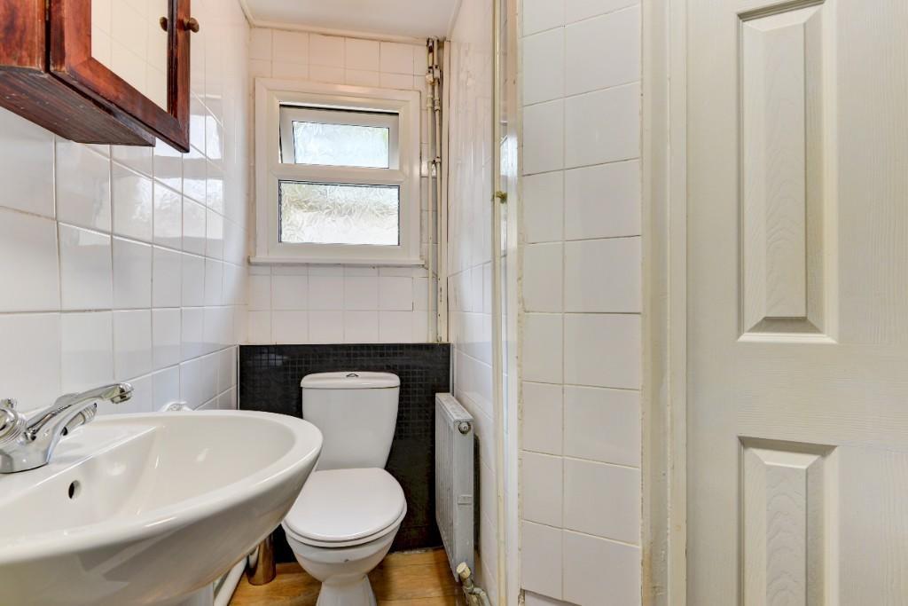 Compact, well-maintained bathroom with a white ...