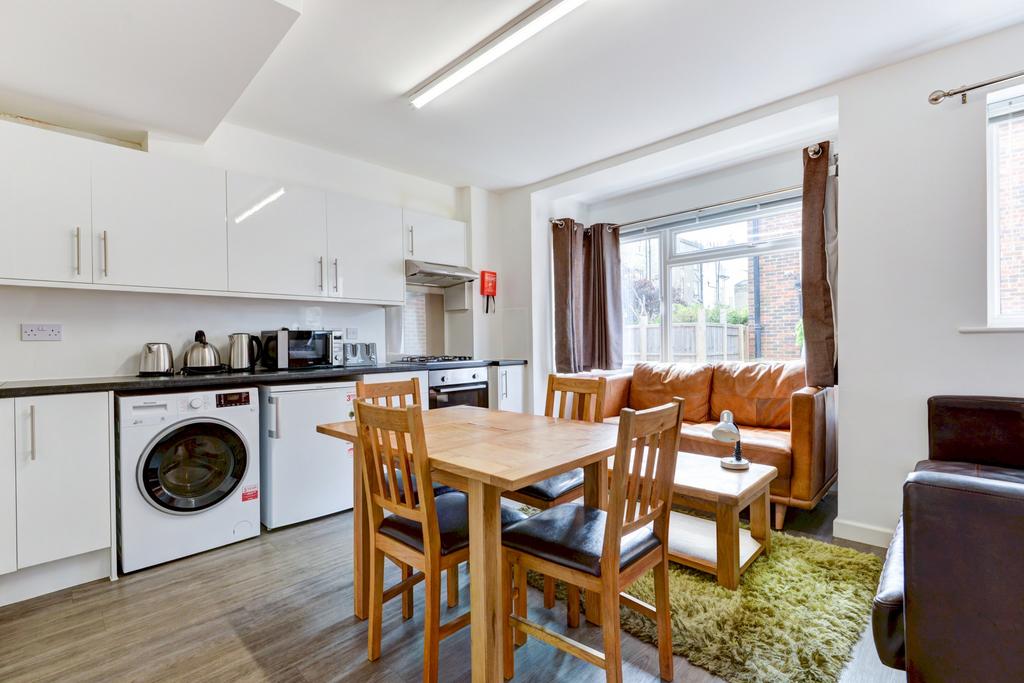 Bright open-plan living area with a dining tabl...