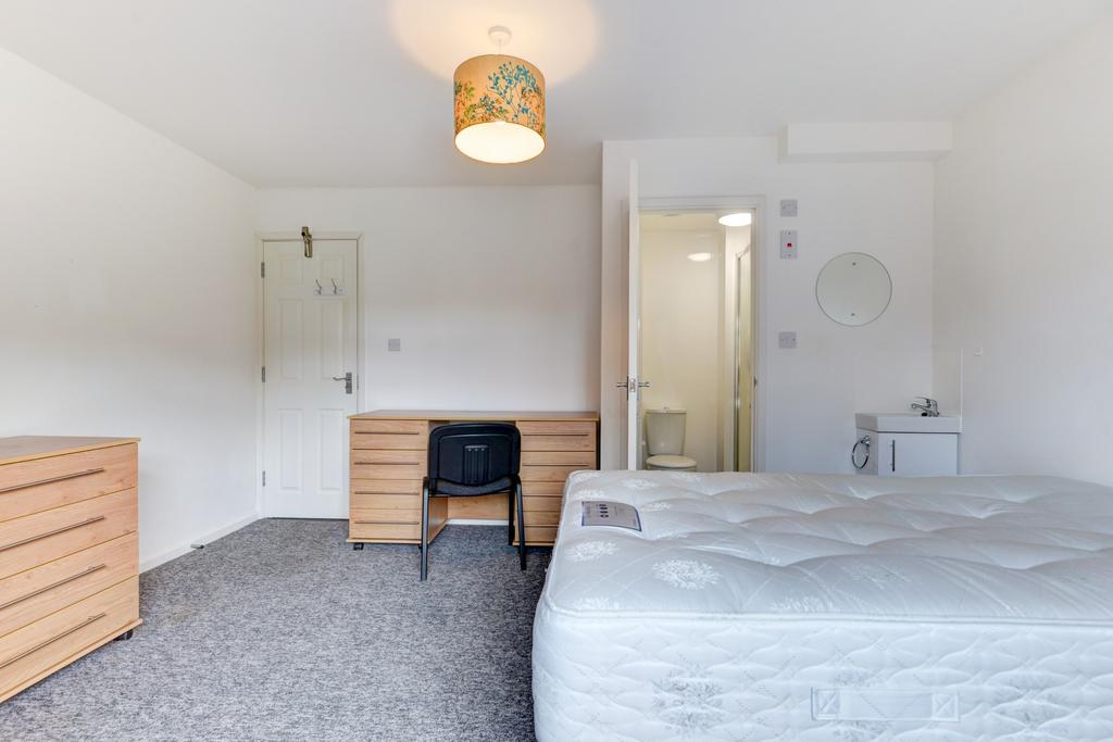 Bright, simply furnished double bedroom with a ...