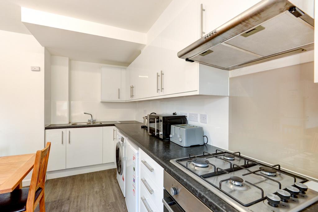 Bright modern kitchen with sleek white cabinets...