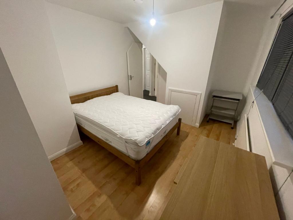A neat and well-maintained bedroom featuring a ...