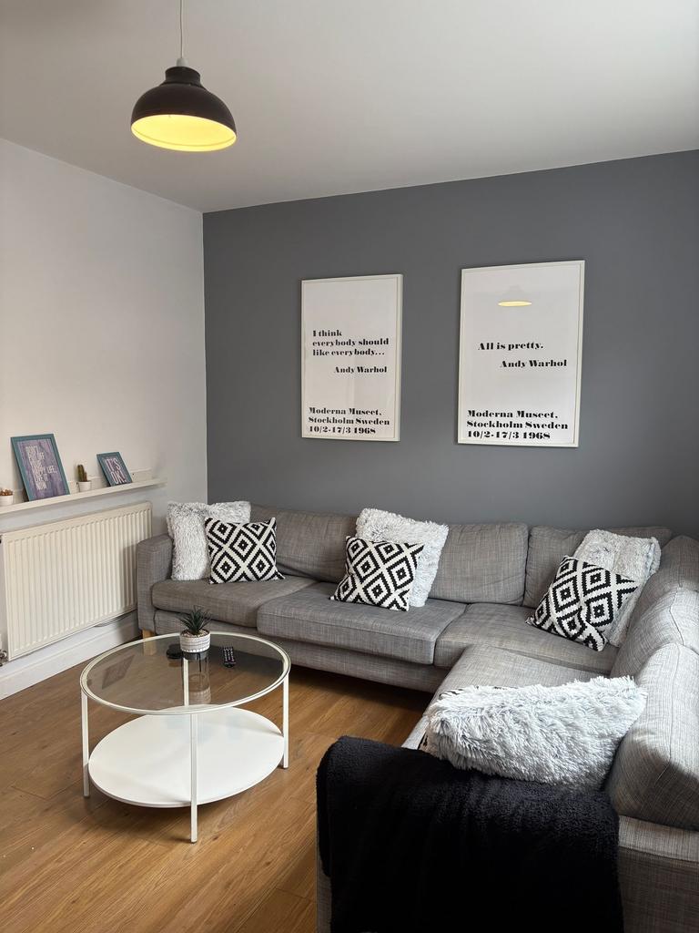 Bright, contemporary living room with a large L...