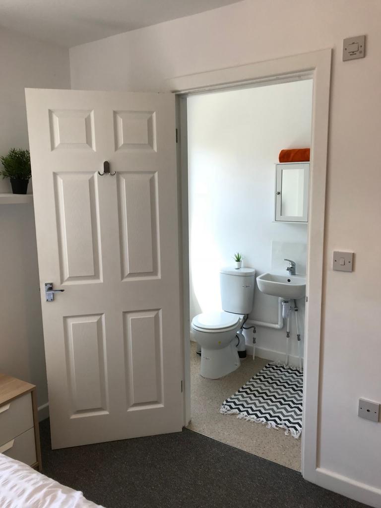 Bright, tidy bedroom with an en‑suite bathroom;...