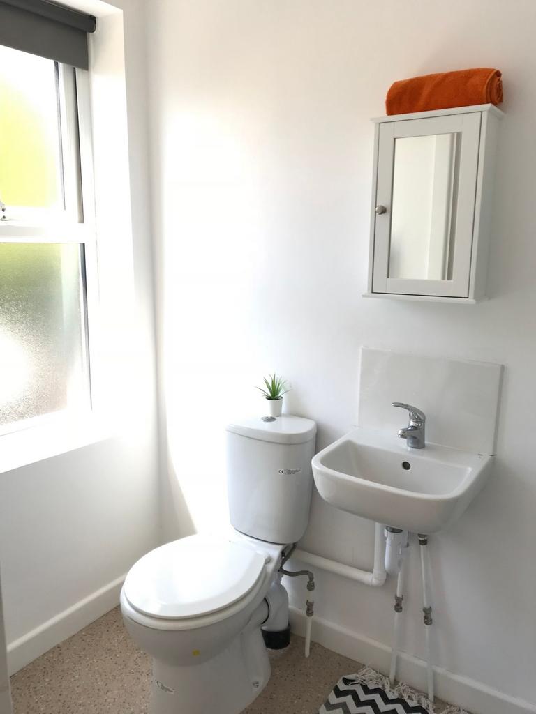 Bright, tidy bathroom with a frosted window, co...