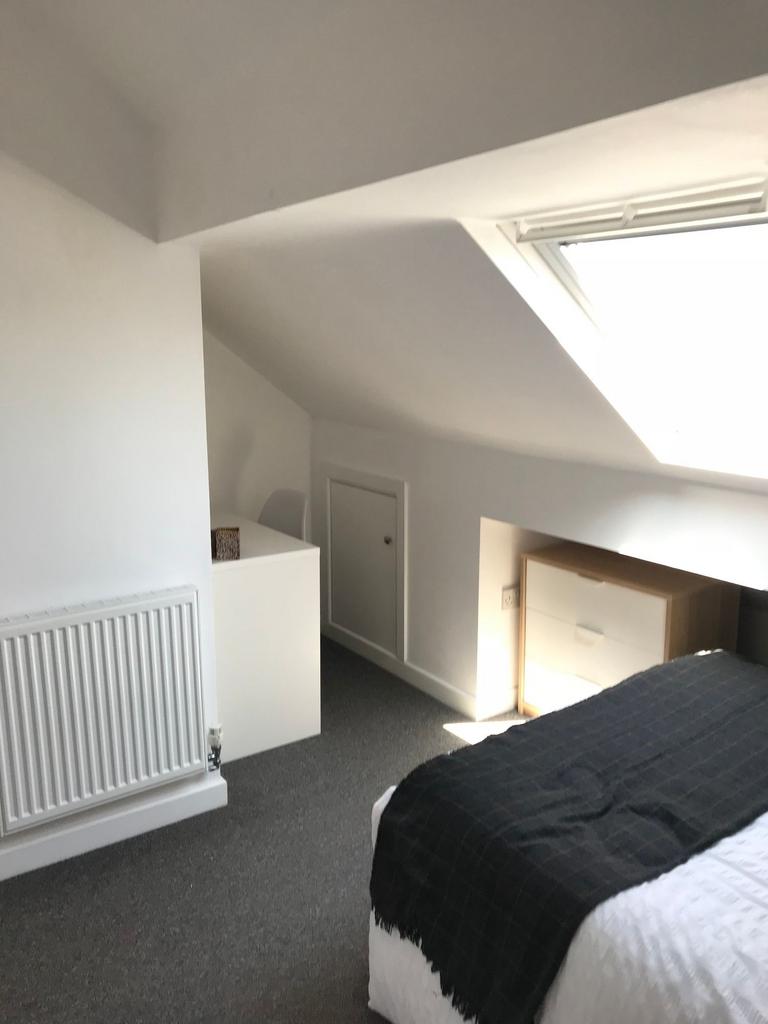 Bright attic double bedroom with a large skylig...