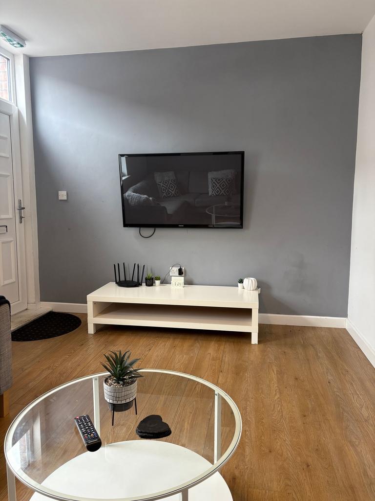 Bright, modern living room with a wall-mounted ...