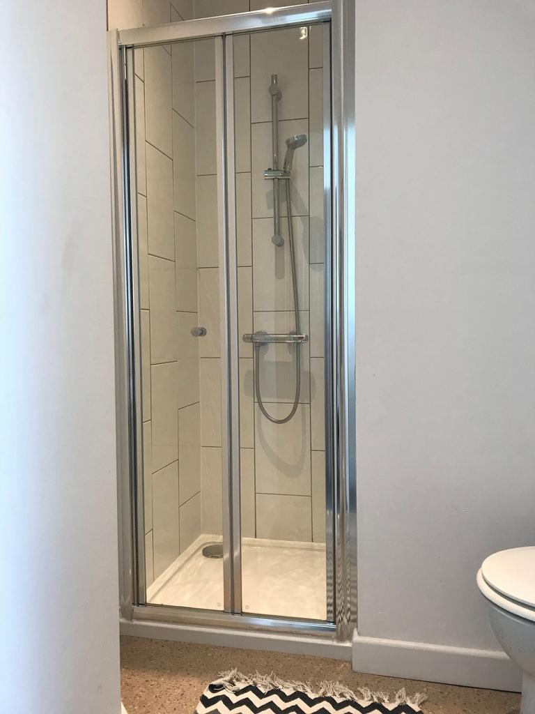 Modern bathroom with a tiled walk-in shower, cl...