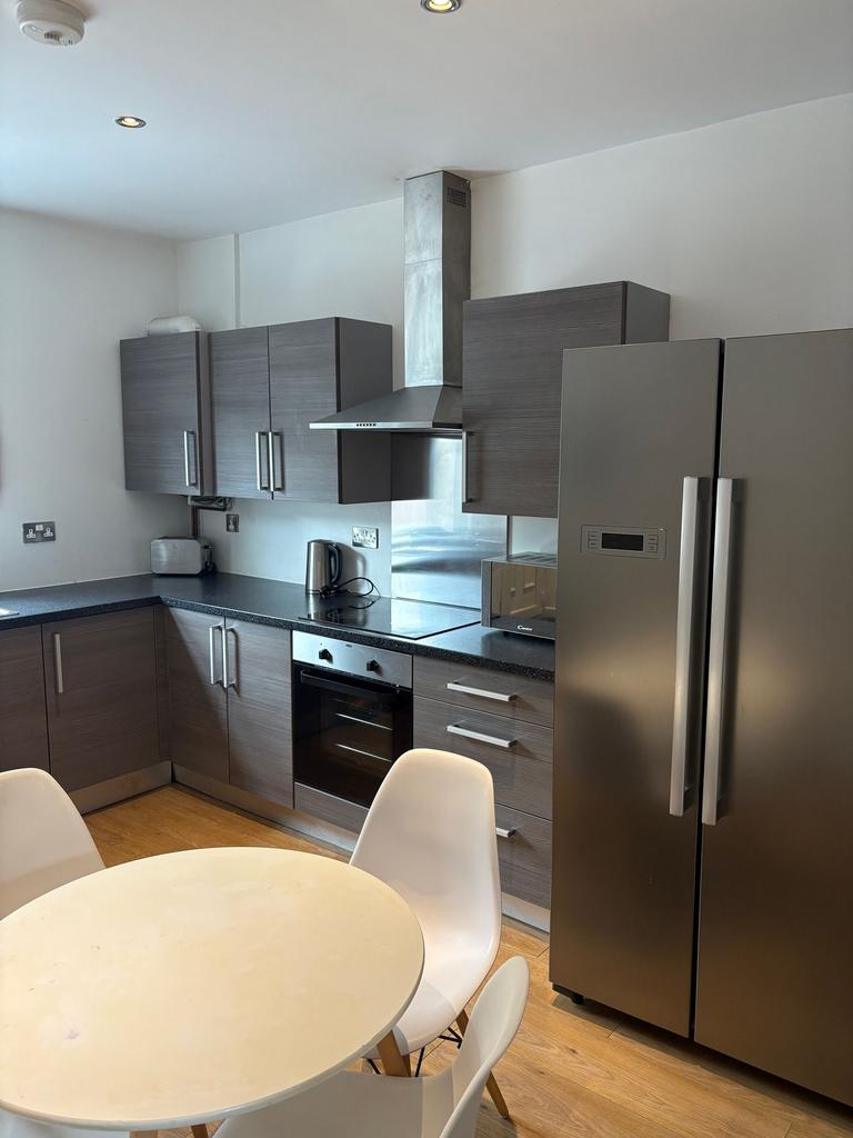 Modern fitted kitchen with grey wood cabinets, ...