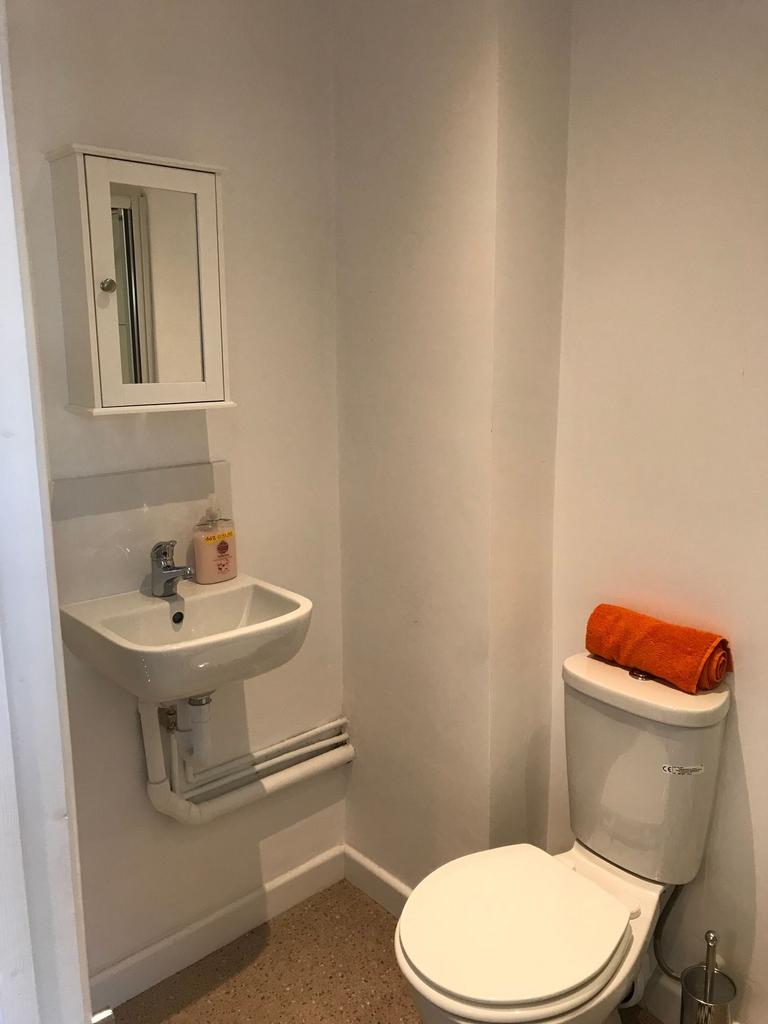 Compact, freshly painted bathroom with a modern...