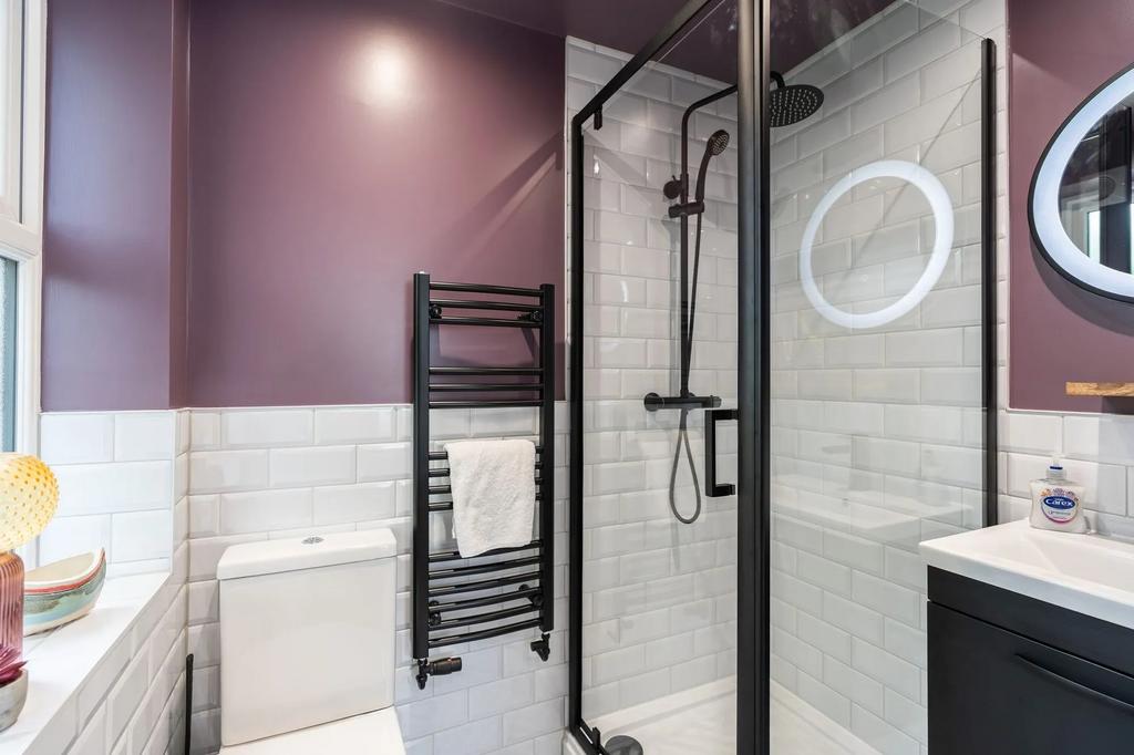 Modern bathroom with white subway tiles, a glas...