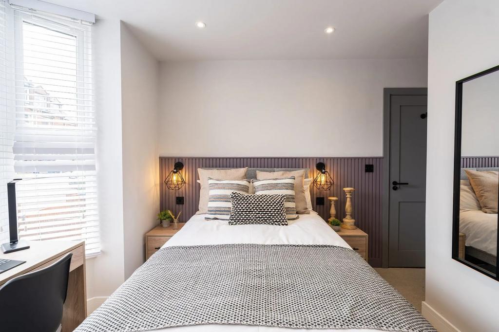 Bright, modern bedroom with a comfortable doubl...