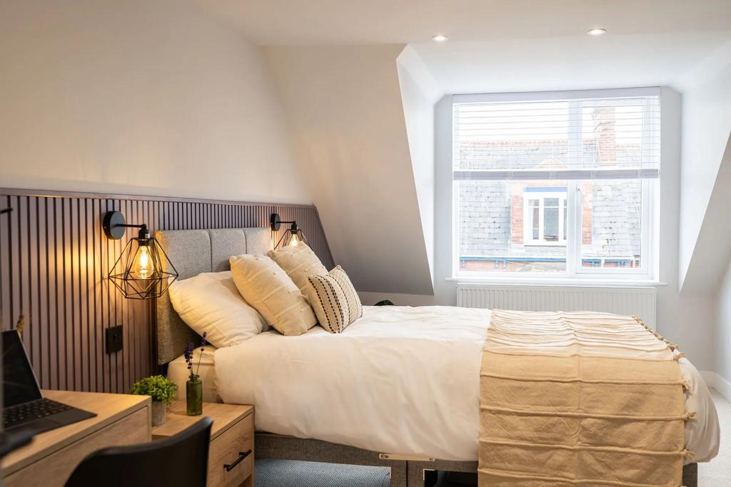 Bright, stylish double bedroom with a comfortab...