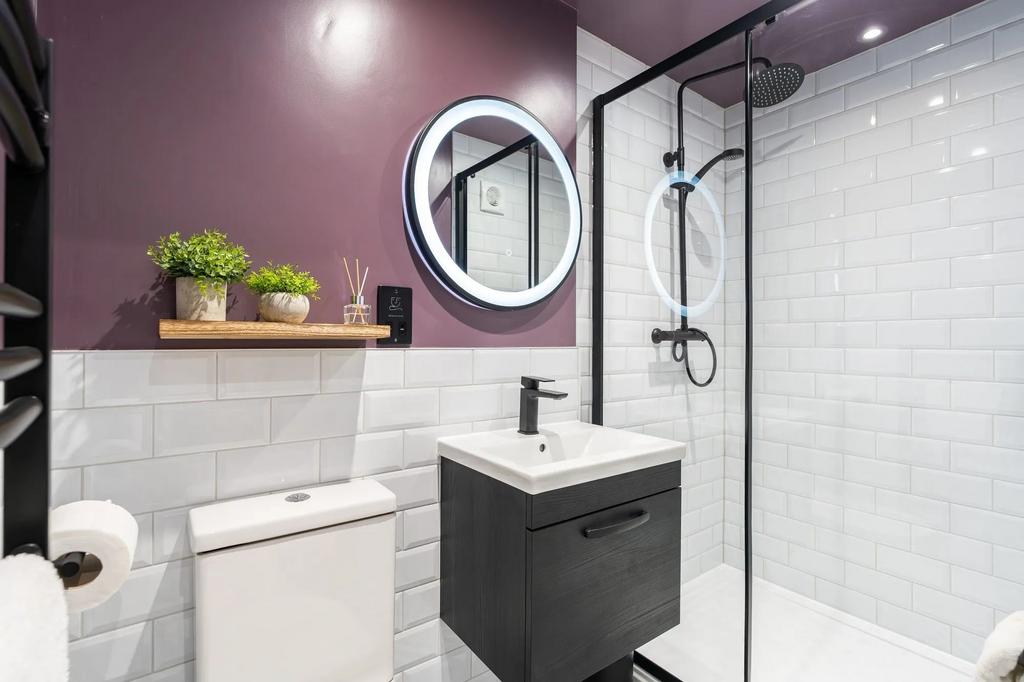 Stylish modern bathroom with white subway tiles...