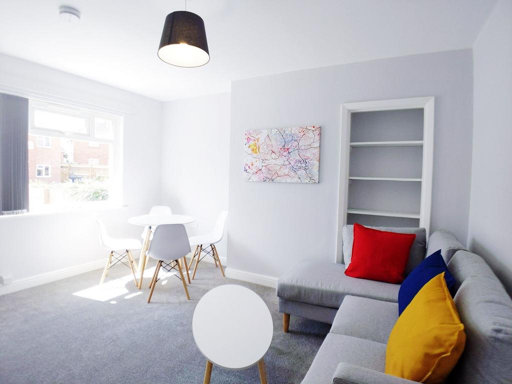 Bright, modern living room with a comfy grey so...