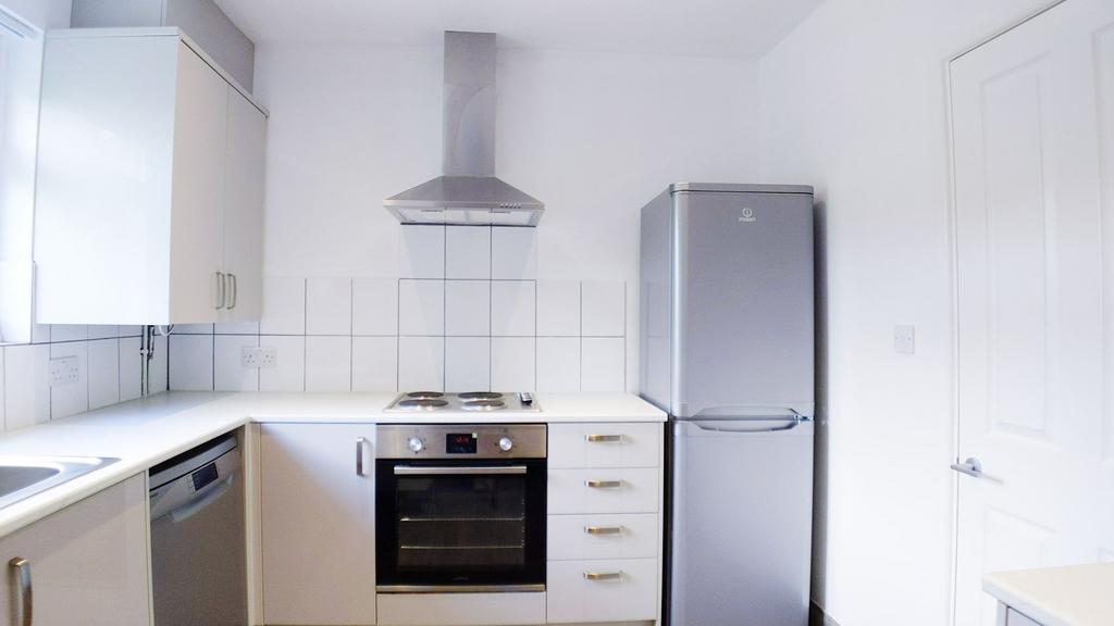 Bright modern kitchen with white cabinets, tile...